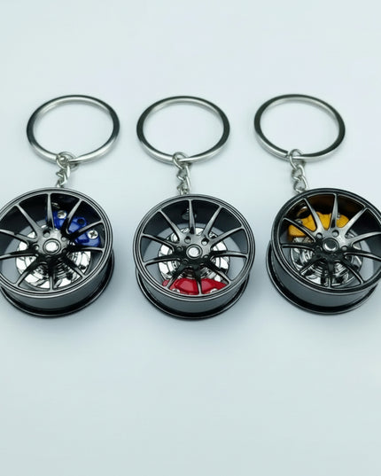 Black metal automotive wheel keychain - blue, red, or yellow caliper