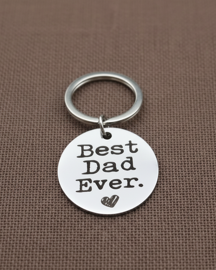 Keychain with 'Best Dad Ever' tag on a brown background