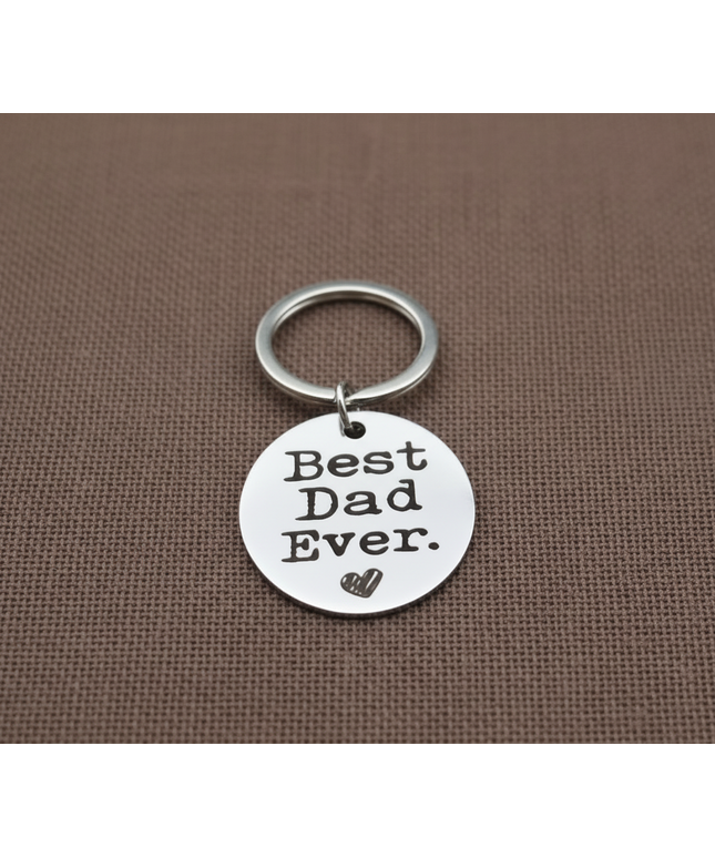 Keychain with 'Best Dad Ever' tag on a brown background