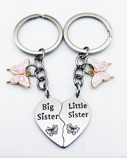 Double silver keychain and charm set that reads "Big Sister" on one and "Little Sister" on the other