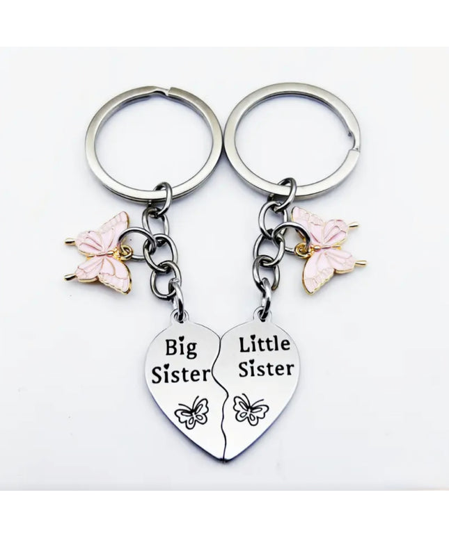 Double silver keychain and charm set that reads "Big Sister" on one and "Little Sister" on the other
