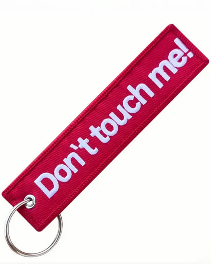 Red embroidered tag with key ring that reads "Don't touch me!"