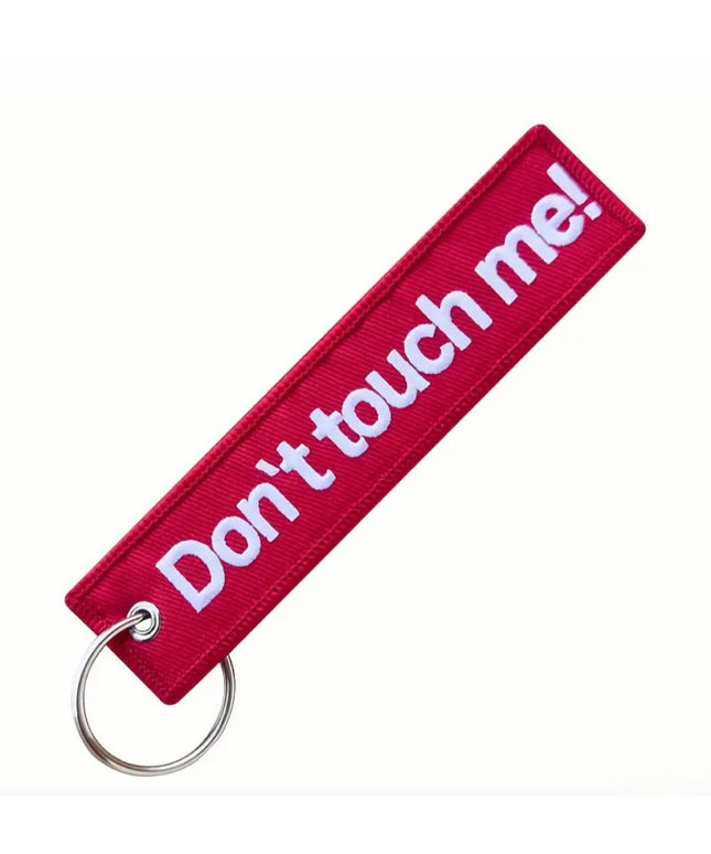 Red embroidered tag with key ring that reads "Don't touch me!"