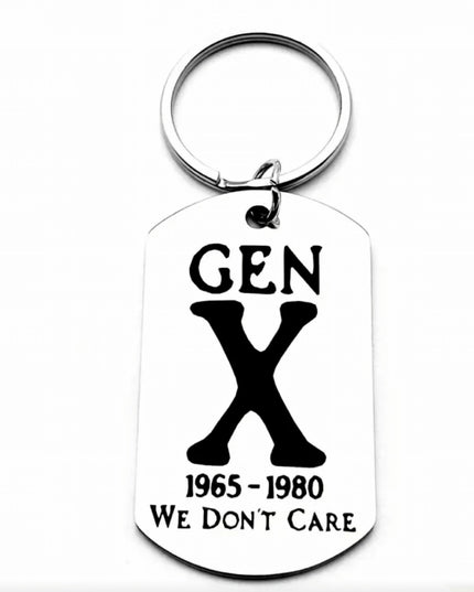 Silver keychain with charm that reads Gen X We Don’t Care etched in black font