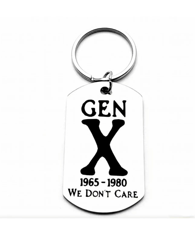 Silver keychain with charm that reads Gen X We Don’t Care etched in black font