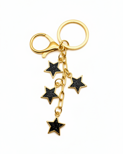 Gold keychain with black star charms on a white background