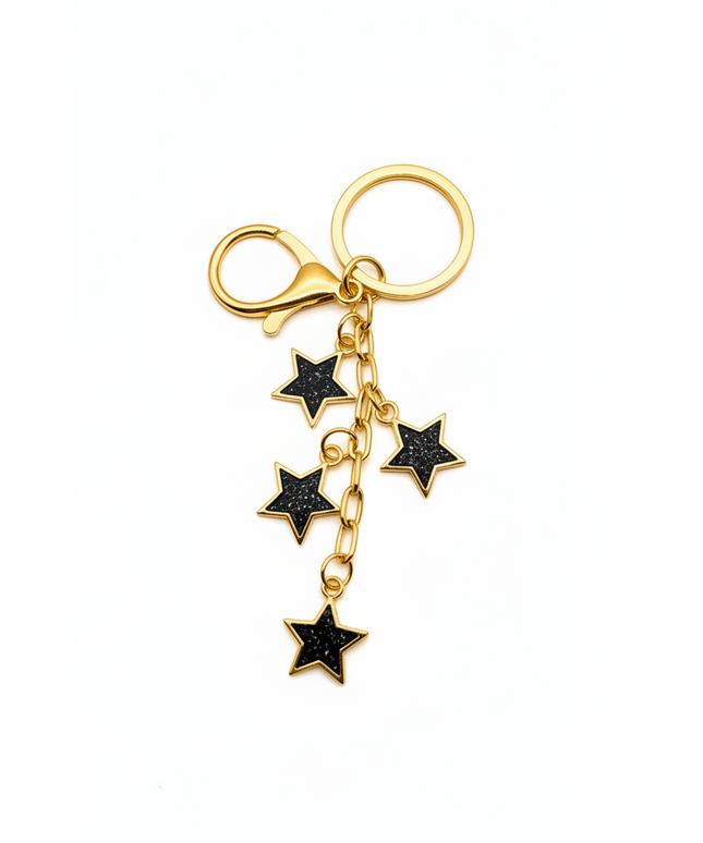 Gold keychain with black star charms on a white background