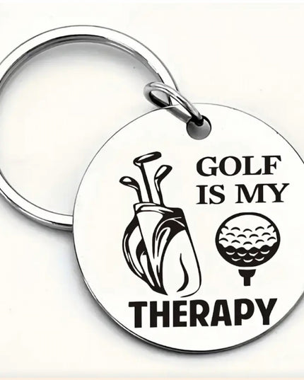 Silver keychain with round charm that says Golf is My Therapy in black font