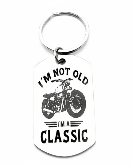 Keychain with motorcycle graphic and text 'I'm not old, I'm a classic' on a white background