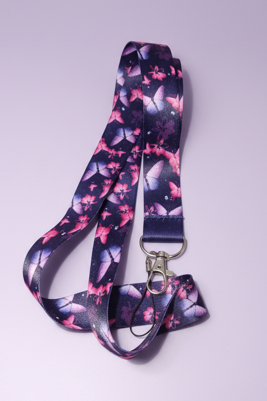 Navy blue lanyard with pink and purple butterflies with lobster clasp and phone charm loop