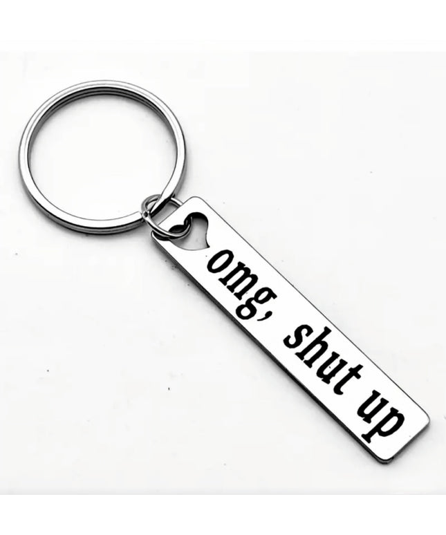 Keychain with 'omg, shut up' tag on a white background