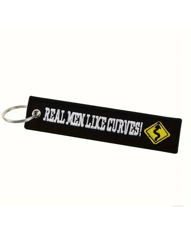 Embroidered Keychain and tag with "Real Men Like Curves" and a yellow curve traffic sign