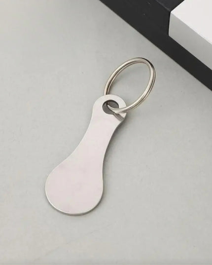 White keychain tag on a light gray surface