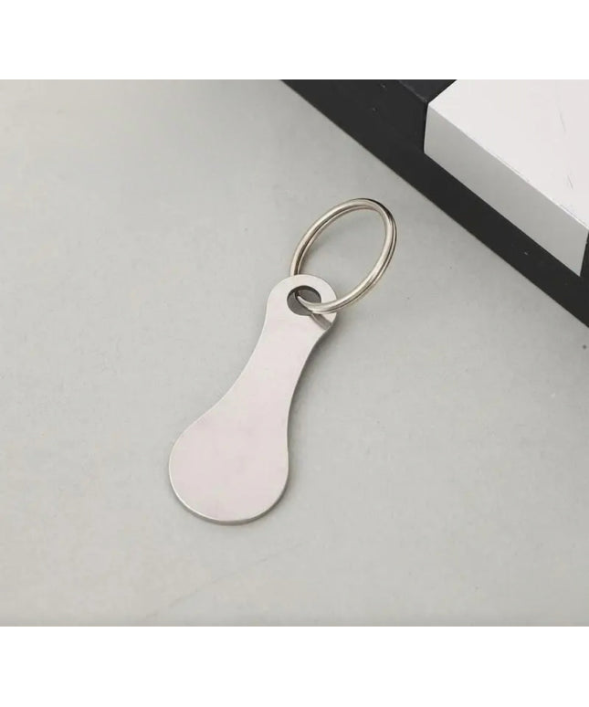 White keychain tag on a light gray surface