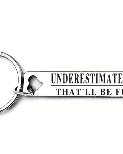 Keychain with 'Underestimate Me That'll Be Fun' text on a white background