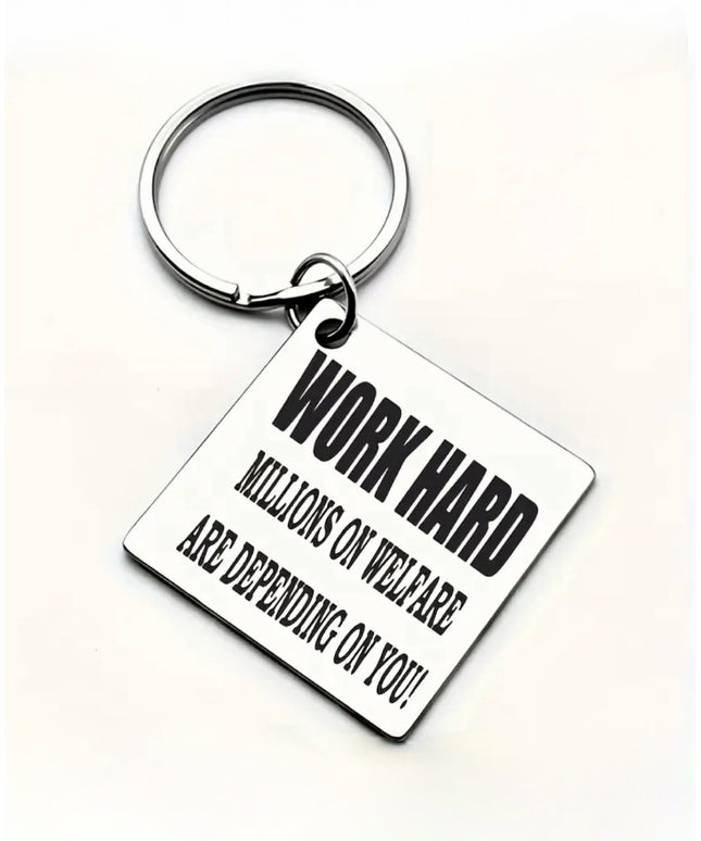 Square silver keychain that reads "Work Hard Millions on Welfare are Depending on You" in black font